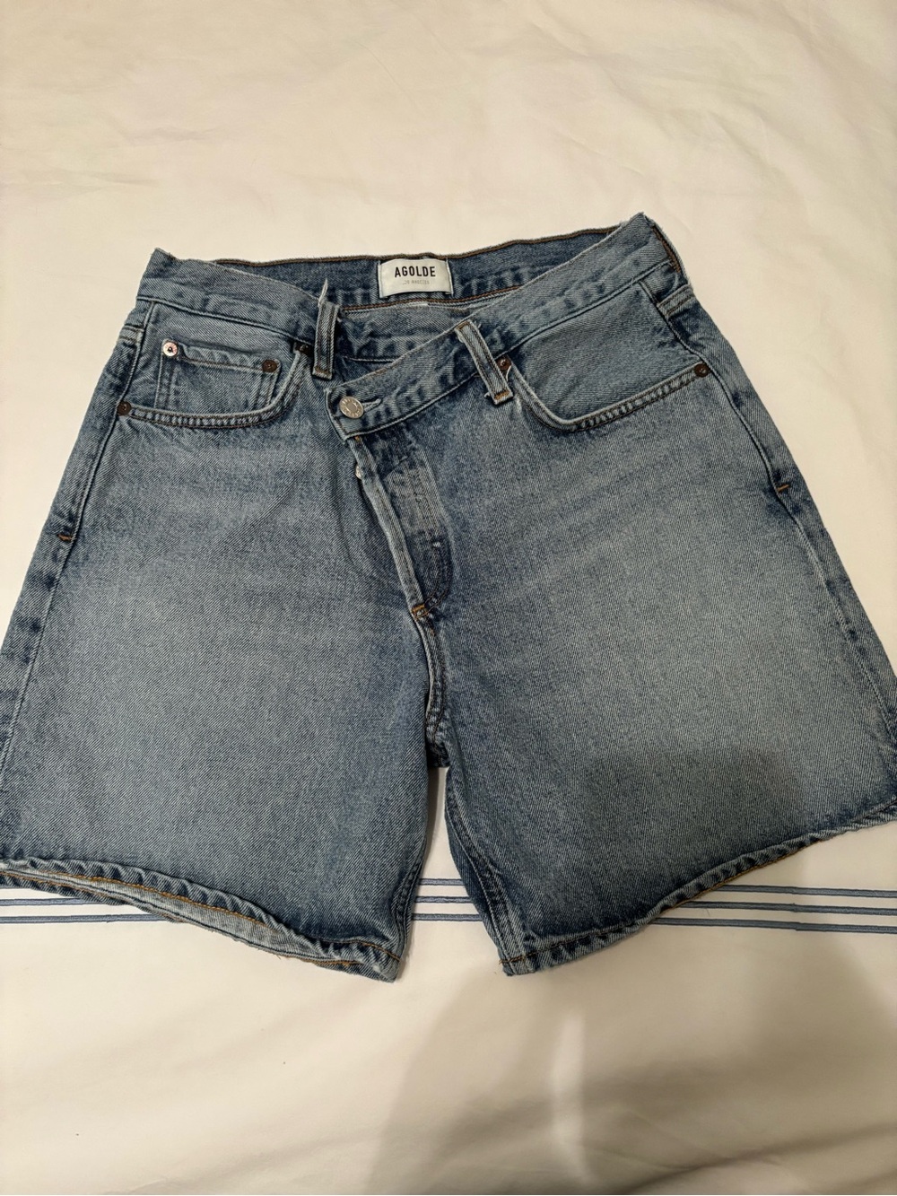 Agolde criss cross denim shorts in Momentum